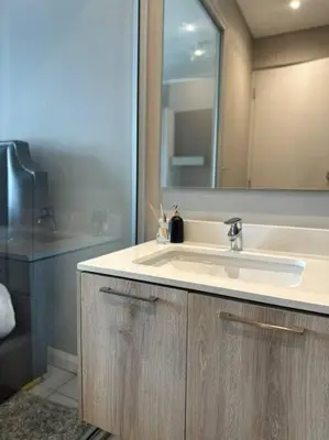 a bathroom with a sink and a mirror at Menlyn Maine Golden Sands in Pretoria