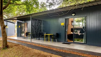 a blue house with a bedroom and a table and chairs at Da Loose Mongoose in White River