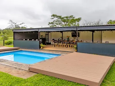 a house with a swimming pool and a patio at Da Loose Mongoose in White River