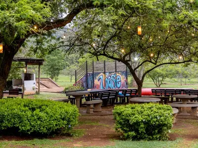 a park with benches and a table with a mural at Da Loose Mongoose in White River