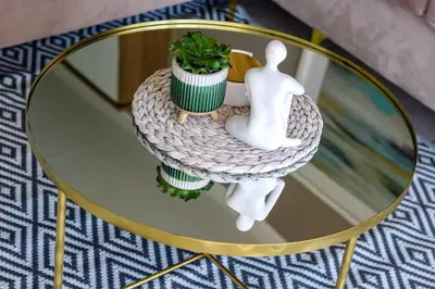 a glass table with a person and a plant on it at The Blyde Tranquil Escapes in Pretoria