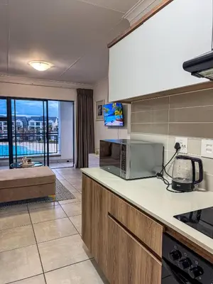 a kitchen with a counter top with a microwave at The Blyde Tranquil Escapes in Pretoria