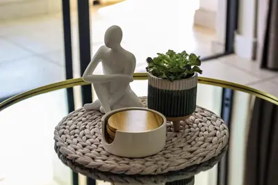 a statue of a person sitting on a table with a cup at The Blyde Tranquil Escapes in Pretoria