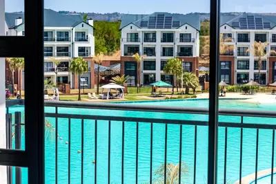 a view of a swimming pool from a hotel balcony at The Blyde Tranquil Escapes in Pretoria