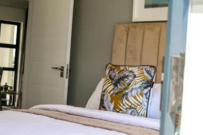a bed with a pillow sitting on top of it at The Blyde Tranquil Escapes in Pretoria