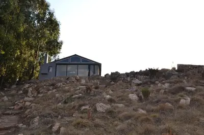 a house sitting on top of a hill at Meadow Mist - Self Catering Unit in Dullstroom