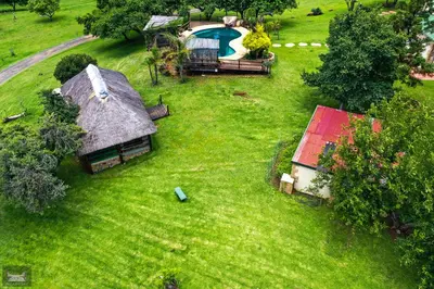 an aerial view of a house with a swimming pool at Indabushe Eco Lodge in Schoemanskloof