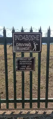 a sign for a driving range on a fence at Indabushe Eco Lodge in Schoemanskloof