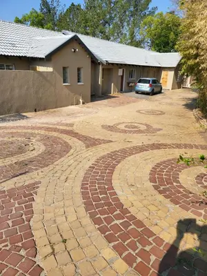 a large brick driveway in front of a house at Limewood super Deluxe in Sandton