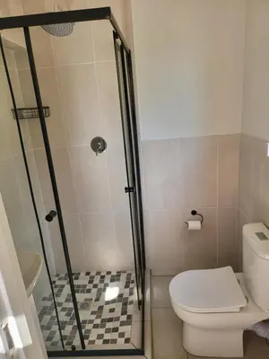 a bathroom with a shower and a toilet at Limewood Vintage in Sandton