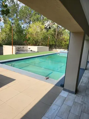 a swimming pool with blue water in a house at Limewood Vintage in Sandton