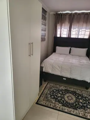 a small bedroom with a bed and a window at Limewood Vintage in Sandton