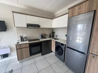 a kitchen with a stainless steel refrigerator and a dishwasher at The blyde in Pretoria