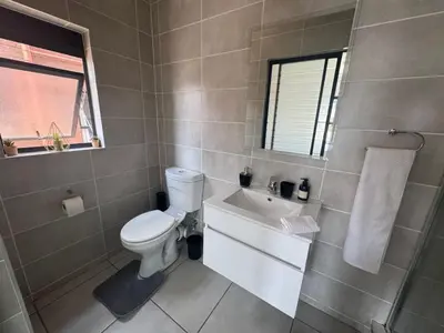 a bathroom with a toilet and a sink at The blyde in Pretoria