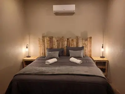 a bedroom with a large bed with two pillows at Cycad Self Catering in Groblersdal