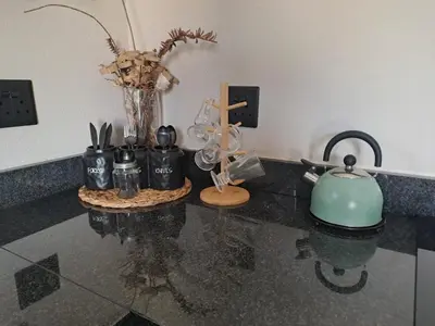 a counter with a teapot and other items on it at Cycad Self Catering in Groblersdal