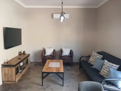 a living room with a couch and a table at Cycad Self Catering in Groblersdal