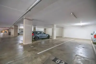a parking garage with a car parked in it at Lovely 1 Bedroom Apartment in Pretoria