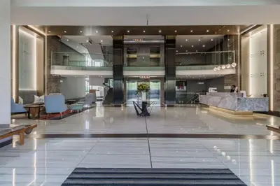 a lobby of a hotel with chairs and tables at Lovely 1 Bedroom Apartment in Pretoria