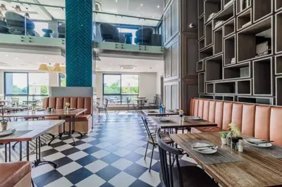 a restaurant with tables and chairs and a checkered floor at Lovely 1 Bedroom Apartment in Pretoria