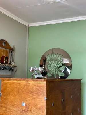 a mirror on top of a wooden cabinet at Guesthouse 52 in Groblersdal