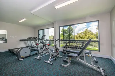 a gym with several exercise equipment in a room at 1 bedroom Apartment in Pretoria