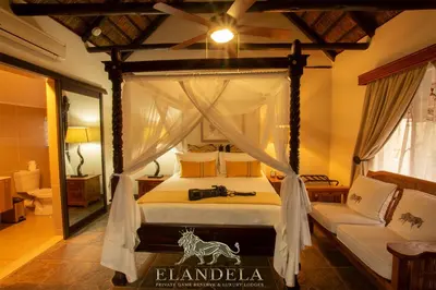 a bedroom with a canopy bed with a camera on it at Elandela Private Game Reserve and Luxury Lodges Pty Ltd in Hoedspruit