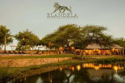 a building with a zebra sign next to a river at Elandela Private Game Reserve and Luxury Lodges Pty Ltd in Hoedspruit