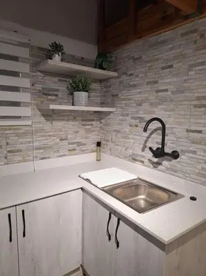 a kitchen with a sink and a counter top at Edel's Nest Nelspruit in Mataffin