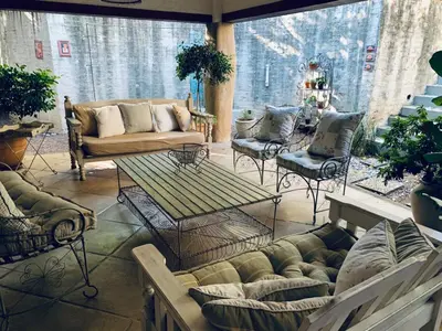 a living room with couches and a table and chairs at Cozy Urban Oasis in Hatfield in Pretoria
