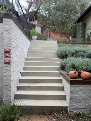 a set of concrete stairs with vases on them at Cozy Urban Oasis in Hatfield in Pretoria