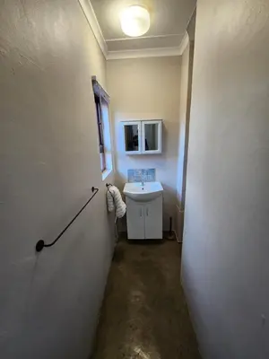 a bathroom with a sink and a white wall at Cozy Urban Oasis in Hatfield in Pretoria