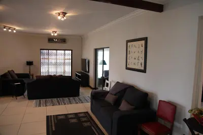 a living room with a couch and a tv at Guest Home KS2E - Self Catering in Kempton Park