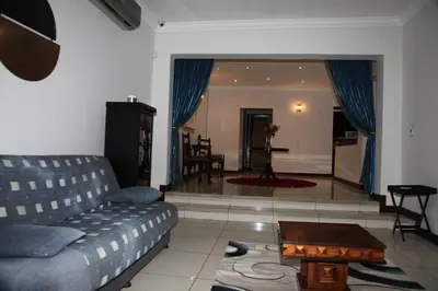 a living room with a couch and a table at Guest Home KS2E - Self Catering in Kempton Park