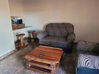 a living room with a chair and a coffee table at Prospectus Accommodation in Northam