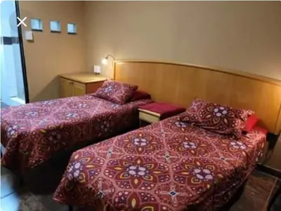 a hotel room with two beds with red covers at Prospectus Accommodation in Northam