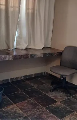 a desk and a chair in front of a window at Prospectus Accommodation in Northam