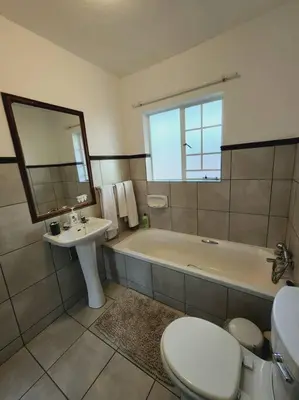a bathroom with a tub and a toilet and a sink at 2d - 50 No load shedding - 2 bedroom in Centurion
