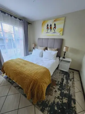 a bedroom with a large bed and a large window at 2d - 50 No load shedding - 2 bedroom in Centurion