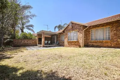a brick house with a yard in front of it at Secured Home in Centurion