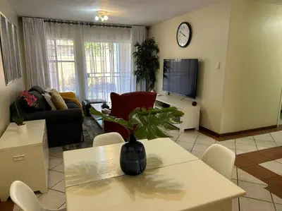 a living room with a vase on a table at 2c - 4 No load shedding 2bed 2bath with garden in Centurion
