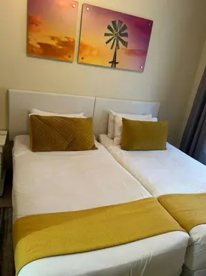 two beds sitting next to each other in a room at 2c - 4 No load shedding 2bed 2bath with garden in Centurion