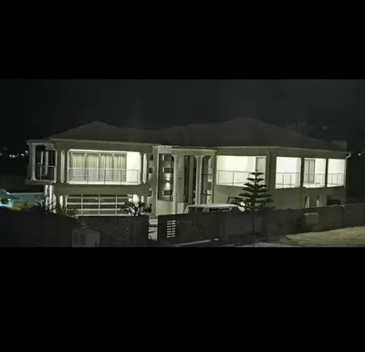 a house with lights on in the dark at Tranquil Space in Nelspruit
