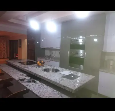 a kitchen counter with a sink and a stove at Tranquil Space in Nelspruit