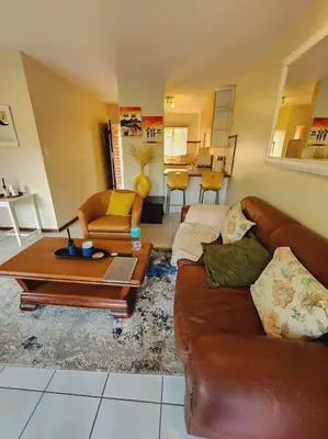 a living room with a couch and a coffee table at 2b - 74 No load shedding - 2 bed home in Centurion