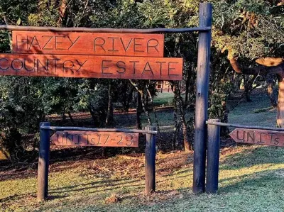 a sign that reads new river country estate at Sycamore Fig House next 2 Hulala Lodge in White River