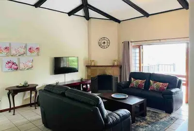 a living room with two couches and a tv at Sycamore Fig House next 2 Hulala Lodge in White River