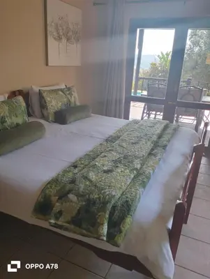 a bed with a blanket on it in a room at Sycamore Fig House next 2 Hulala Lodge in White River