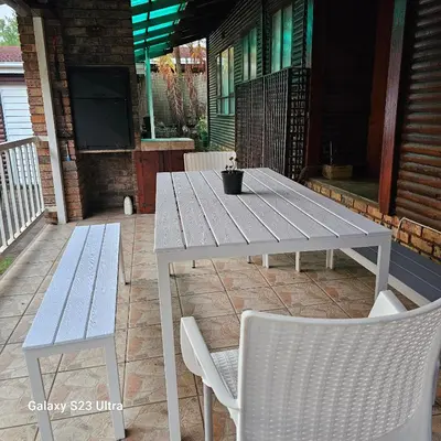 a picnic table and two chairs on a patio at Yello guest house chalets in Graskop