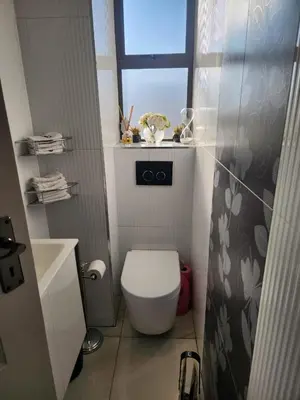 a small bathroom with a toilet and a window at Blue Valley Golf Estate in Centurion